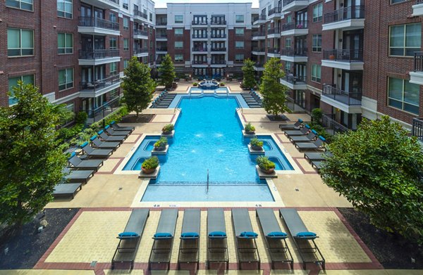 Luxurious outdoor pool area with lounge seating at Virage Luxury Apartments, perfect for relaxation and social gatherings