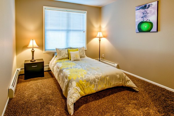 Modern bedroom with plush bedding and natural light at Fair Hills Apartments in Texas