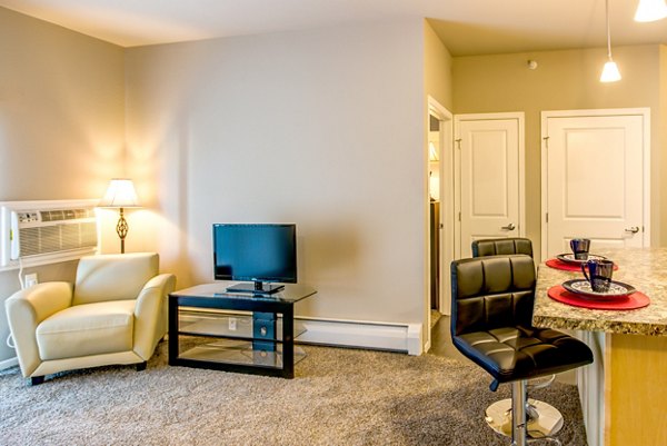 Spacious living room with modern decor and natural lighting at Fair Hills Apartments