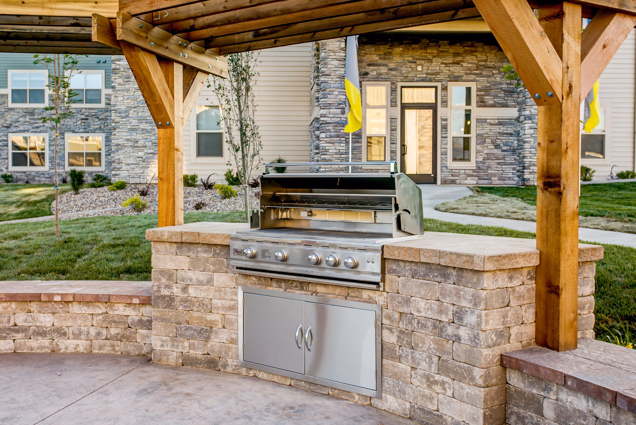 Outdoor grill area with seating at Fair Hills Apartments, ideal for socializing and dining in style