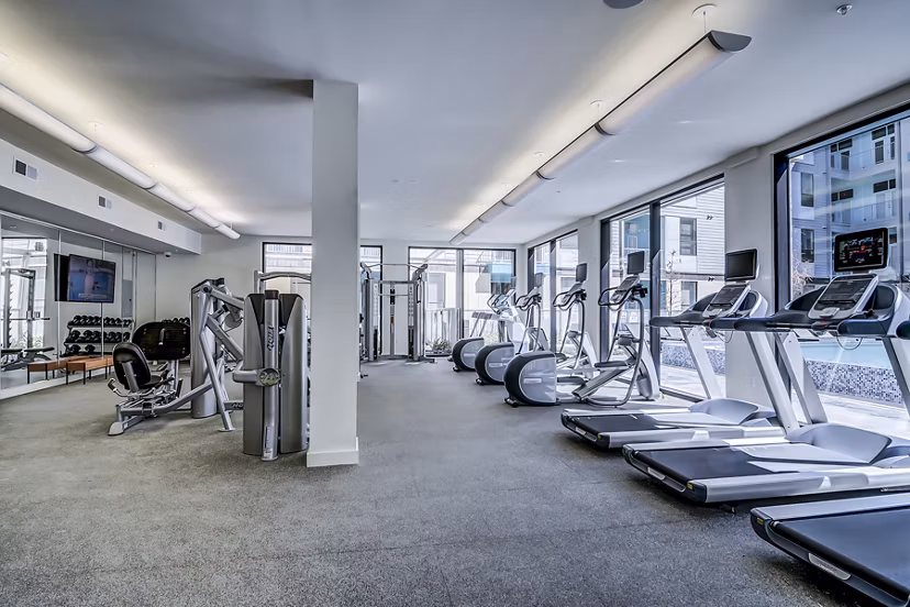 State-of-the-art fitness center featuring cardio equipment at Agave Apartments