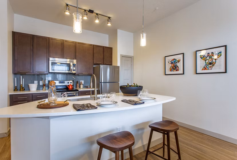 Modern kitchen with stainless steel appliances in Agave Apartments