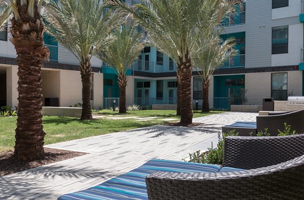 Patio with modern seating and greenery at Agave Apartments, a luxury living space by Greystar