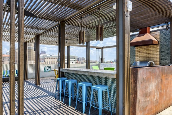 Outdoor patio with grill area at Agave Apartments