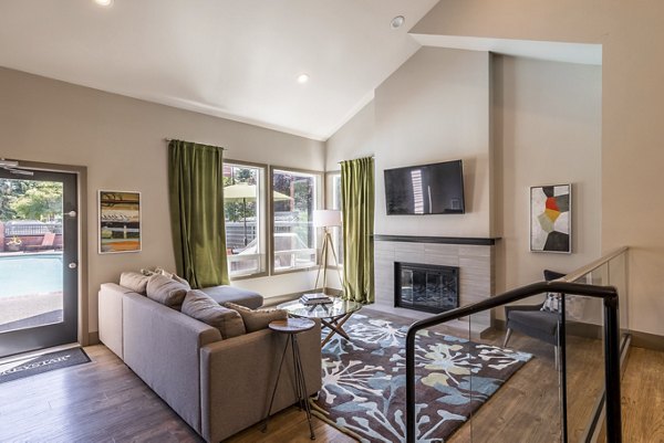 Clubhouse with modern decor and seating at The Seasons Apartments offering luxury living and communal spaces for residents