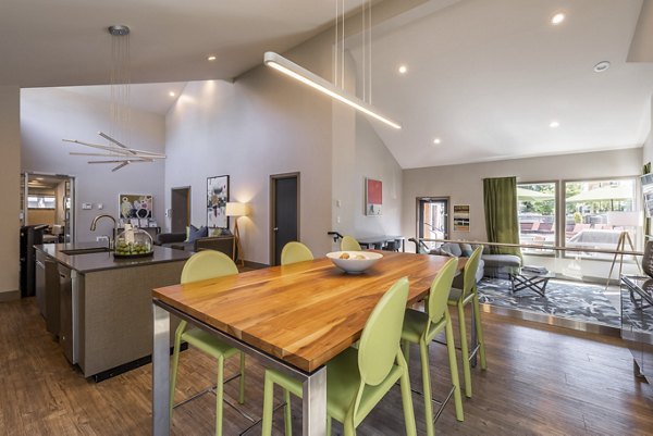 Clubhouse at The Seasons Apartments: Spacious social area with modern seating and entertainment options, ideal for community gatherings and events