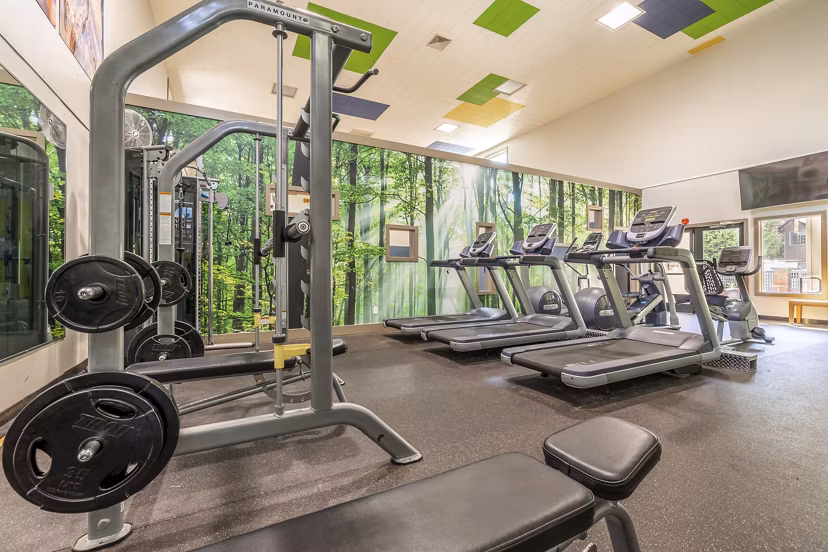Modern fitness center with state-of-the-art equipment at The Seasons Apartments