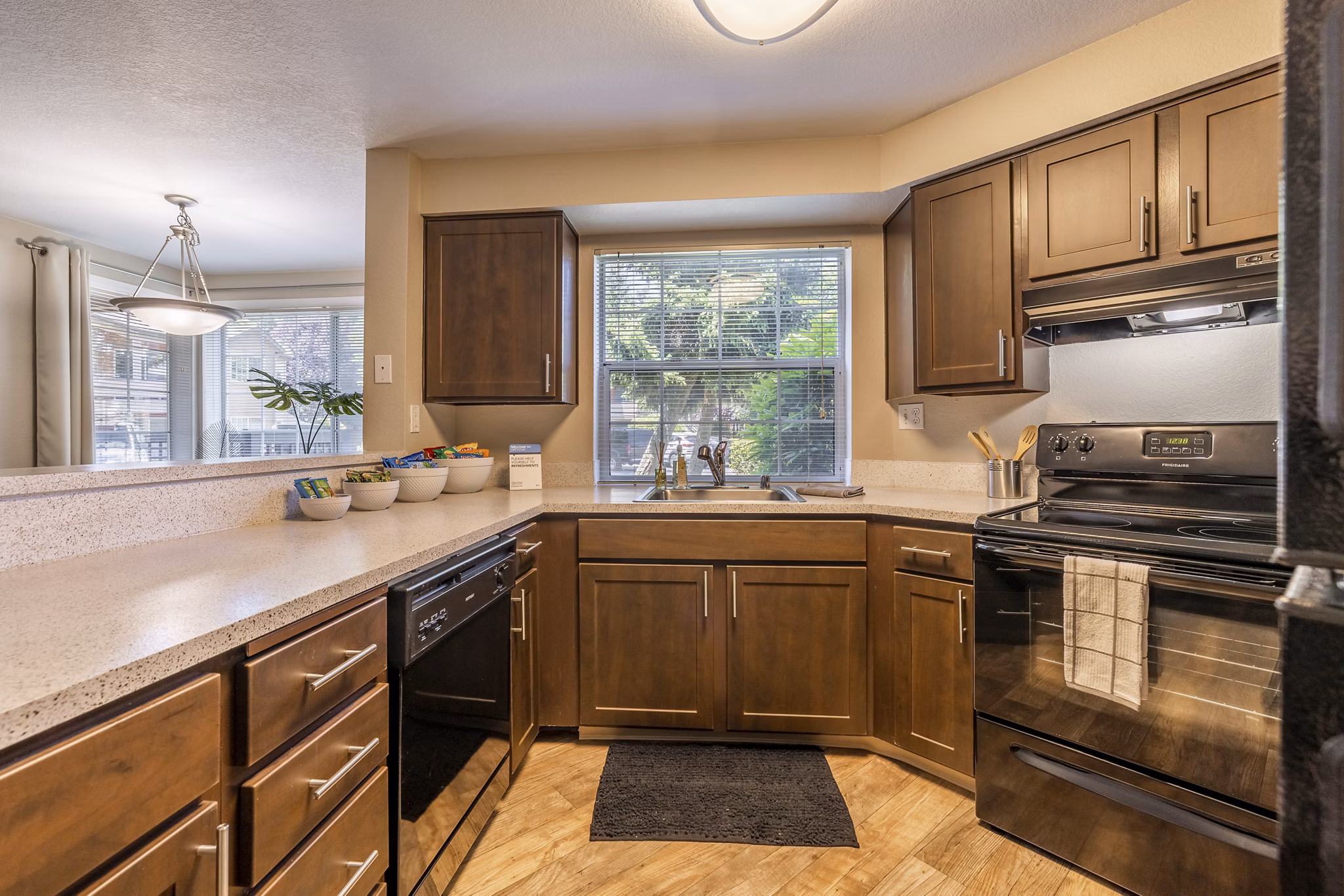 Modern kitchen with stainless steel appliances at The Seasons Apartments, luxury living by Greystar in a convenient location