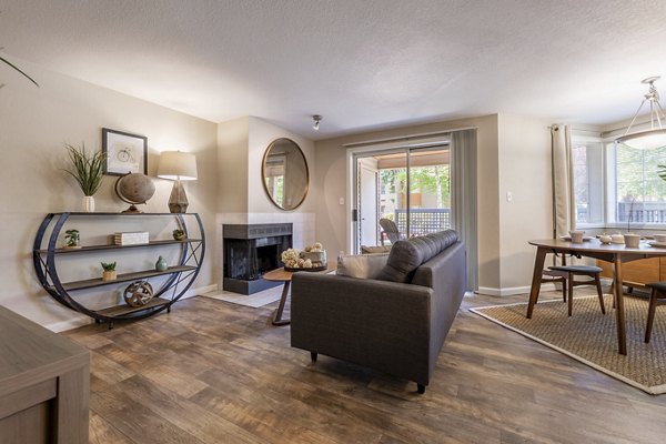 Spacious living room with modern decor in The Seasons Apartments