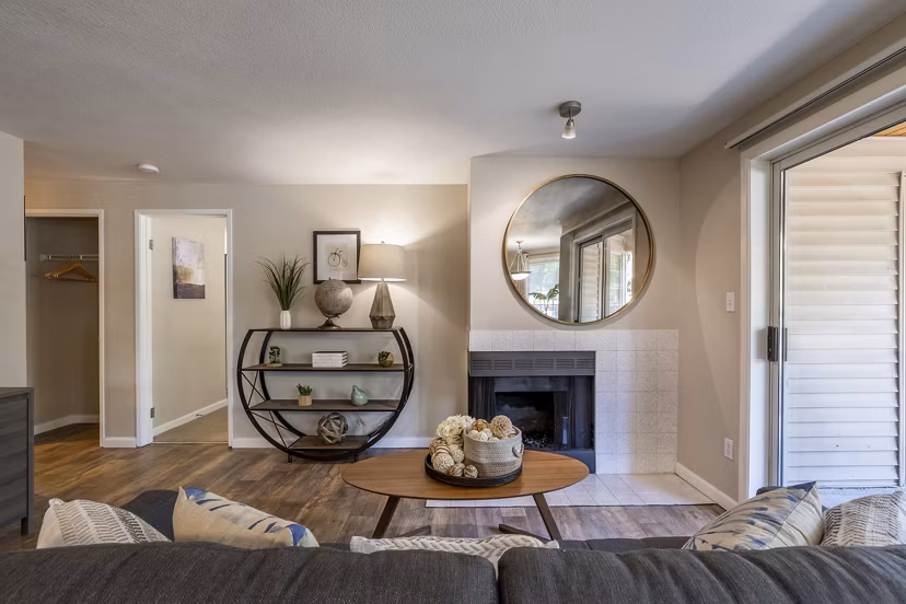 Cozy living room with a fireplace and modern decor in The Seasons Apartments