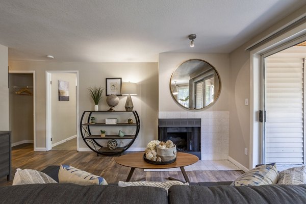 Cozy living room with a fireplace and modern decor in The Seasons Apartments