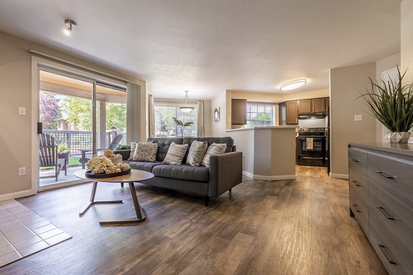 Spacious living room with elegant decor in The Seasons Apartments, offering a cozy and modern living experience in luxury apartments