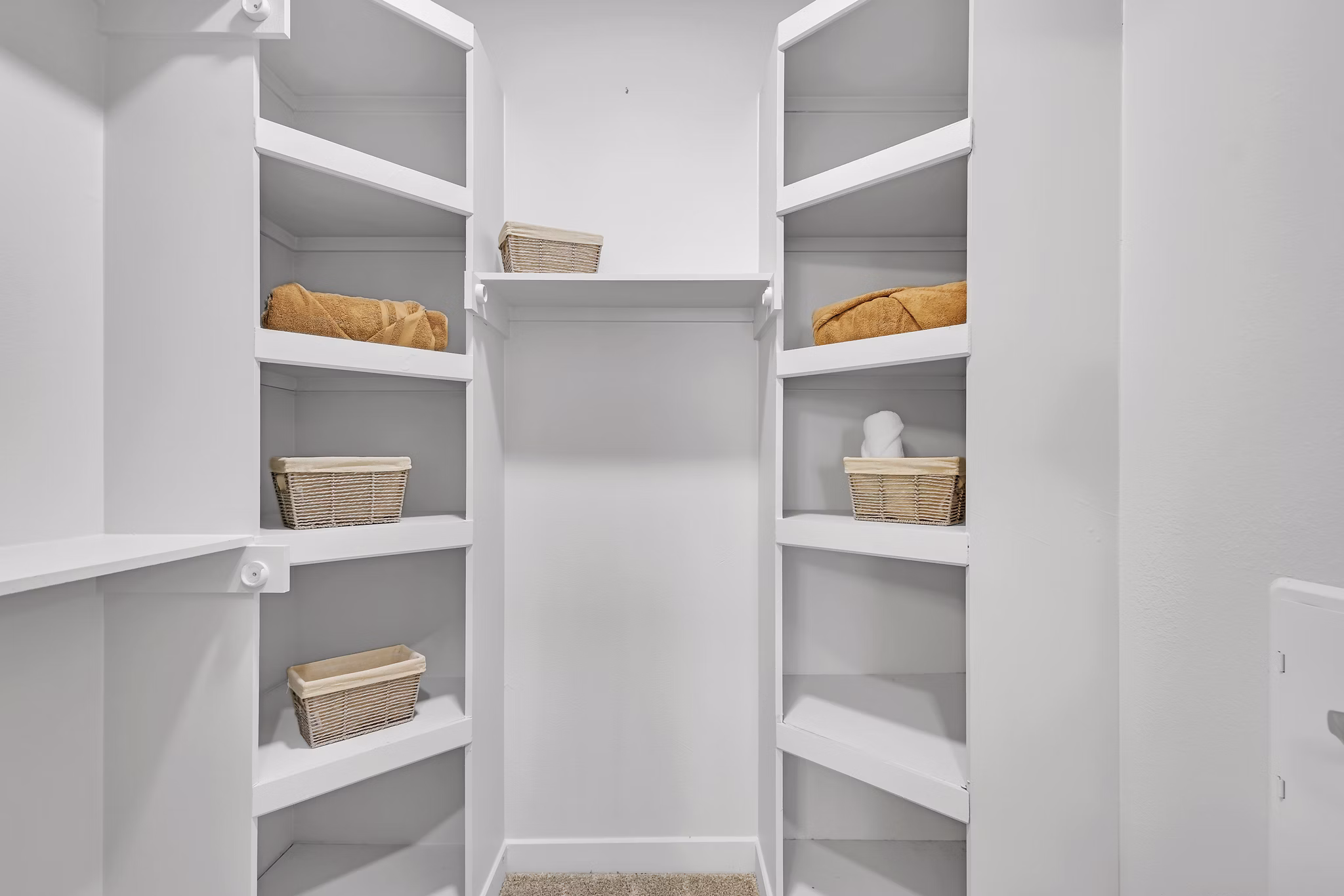 Closet with custom shelving and ample storage space in Oak & Ellum Apartments