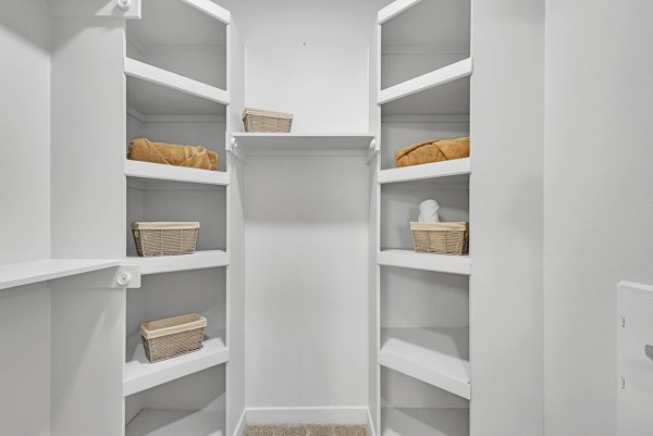 Closet with custom shelving and ample storage space in Oak & Ellum Apartments