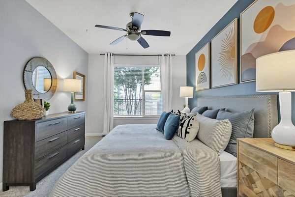 Modern bedroom with elegant decor at Oak & Ellum Apartments, showcasing luxury living in Greystar's exclusive residential community