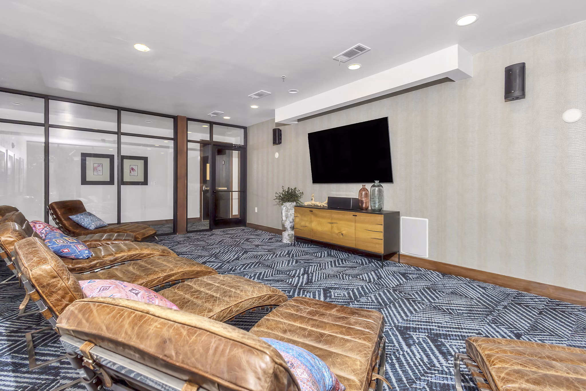 Theater with plush seating and large screen at Oak & Ellum Apartments, luxury living with premium entertainment spaces