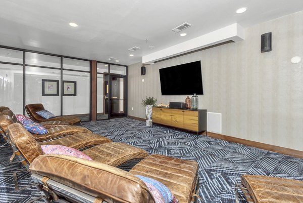 Theater with plush seating and large screen at Oak & Ellum Apartments, luxury living with premium entertainment spaces