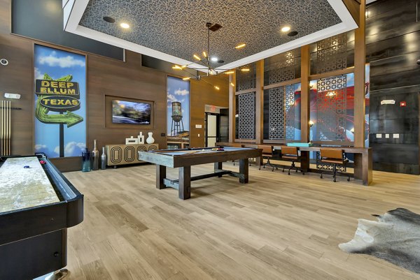 Game room with pool table and lounge area at Oak & Ellum Apartments