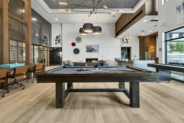 Game room with modern entertainment options at Oak & Ellum Apartments