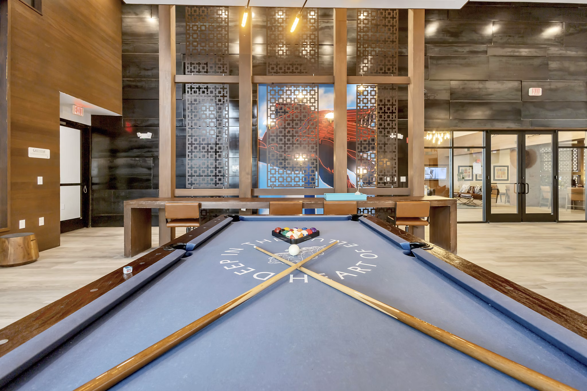 Modern game room with a pool table and decorative walls in luxury apartments