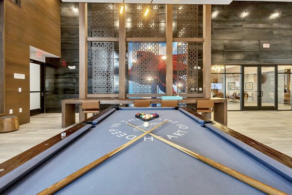 Modern game room with a pool table and decorative walls in luxury apartments
