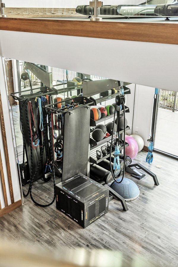 Modern fitness center with state-of-the-art equipment at Oak & Ellum Apartments