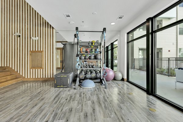 State-of-the-art fitness center at Oak & Ellum Apartments with modern equipment for residents' health and wellness