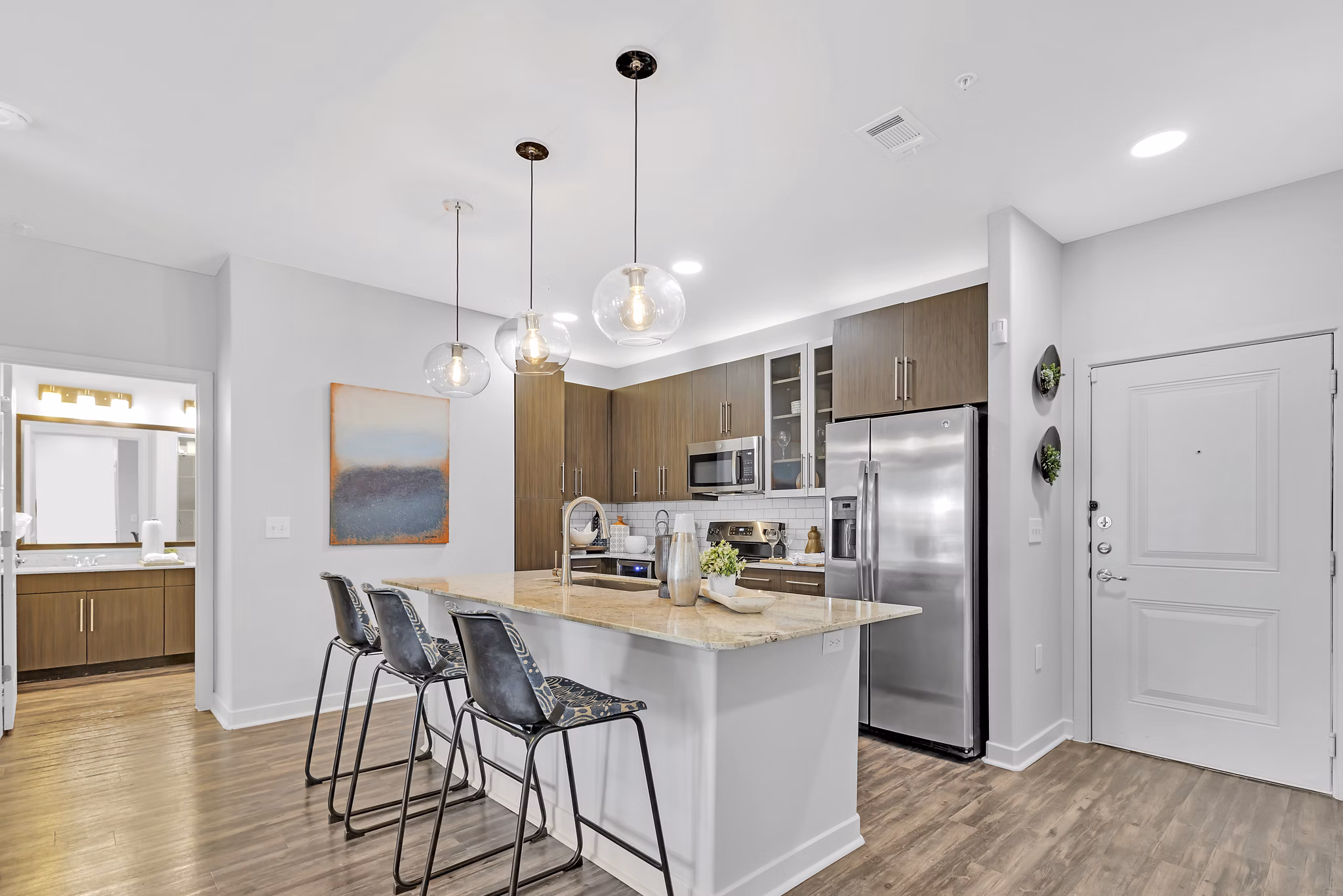 Modern kitchen with stainless steel appliances at Oak & Ellum Apartments, luxury living with premium amenities in the heart of downtown