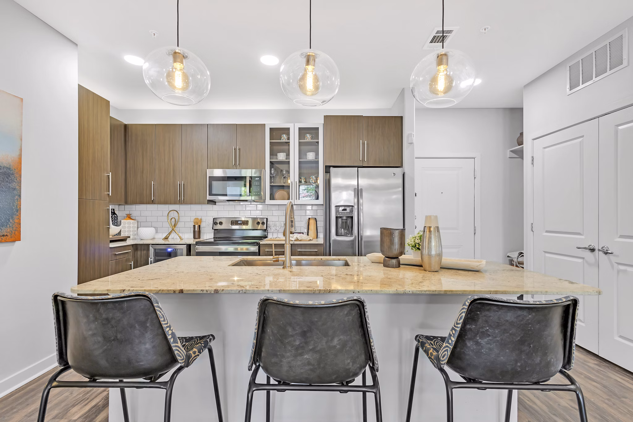 Modern kitchen with stainless steel appliances at Oak & Ellum Apartments in Greystar luxury community