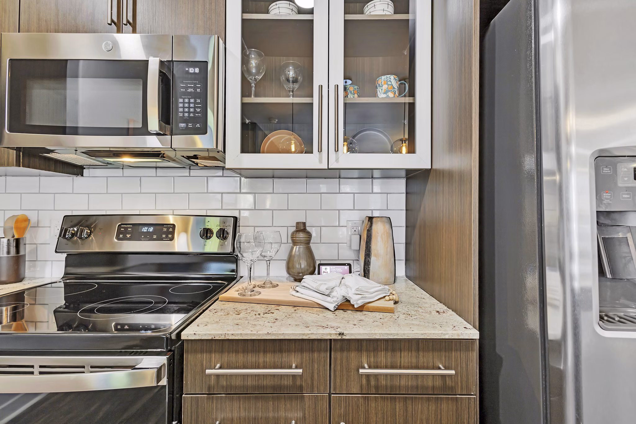 Elegant kitchen with sleek cabinetry and stainless steel appliances in Oak & Ellum Apartments, a luxury living option in a vibrant community
