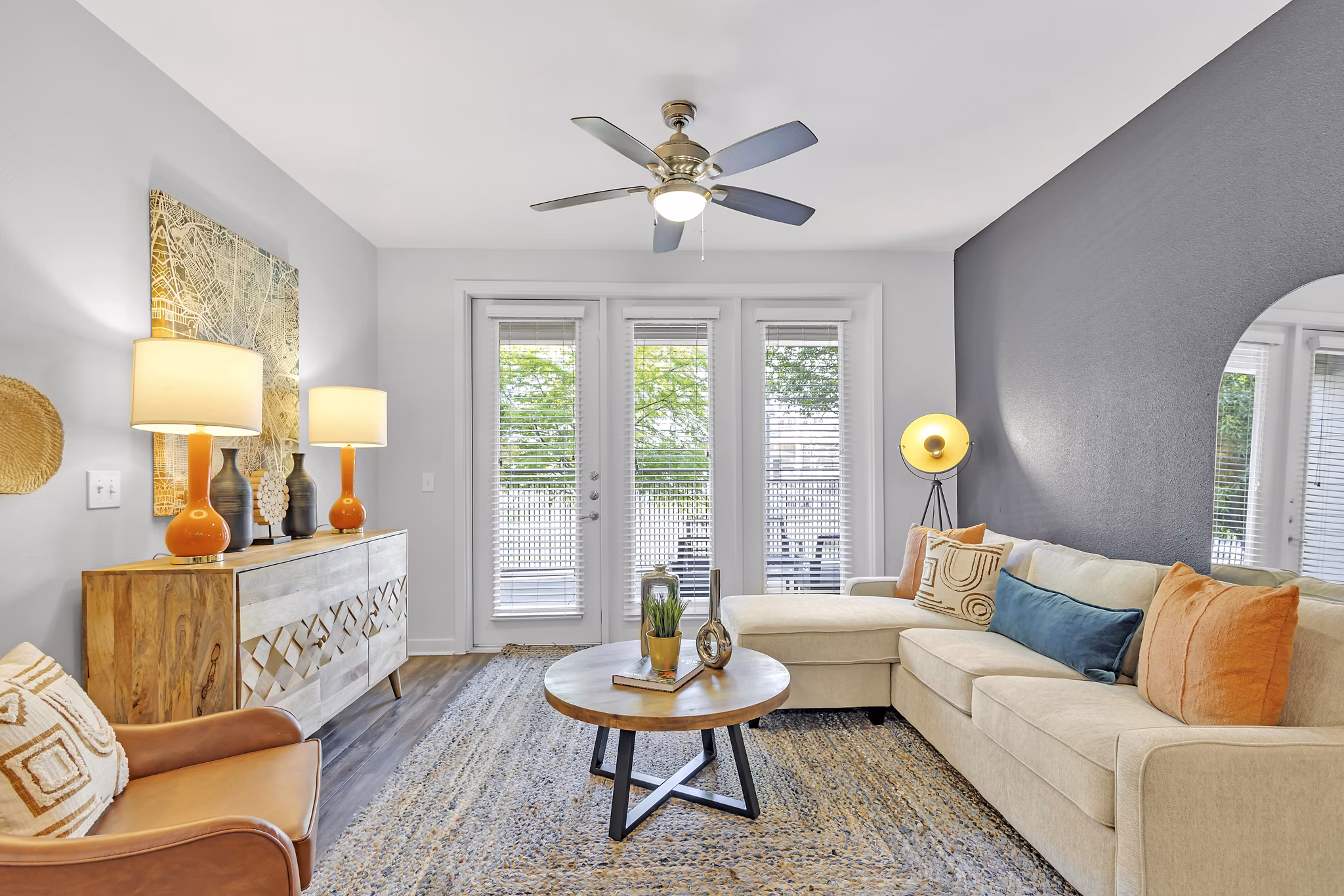 Modern living room with plush seating and vibrant artwork at Oak & Ellum Apartments, a Greystar luxury residence