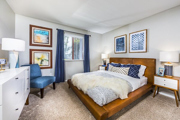 Bedroom featuring modern decor and large windows at Avana Rancho Cucamonga Apartments Perfect blend of comfort and style in a luxury setting