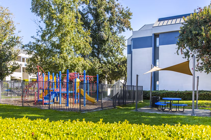 Children's playground with vibrant equipment at Avana Rancho Cucamonga Apartments