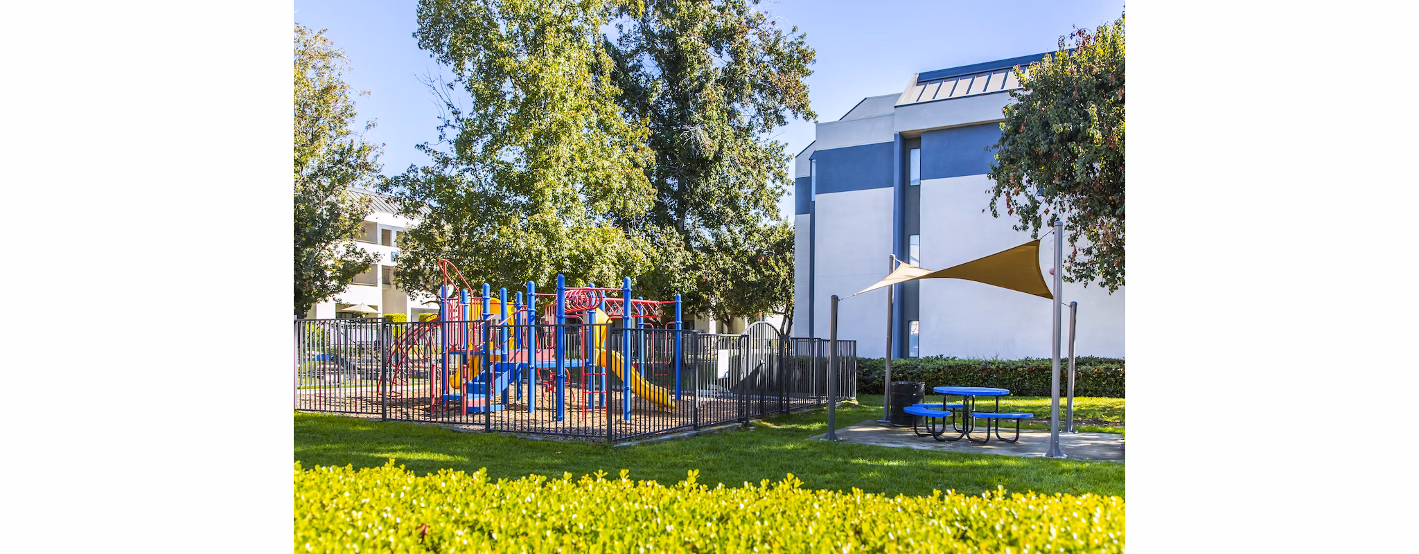 Children's playground with vibrant equipment at Avana Rancho Cucamonga Apartments