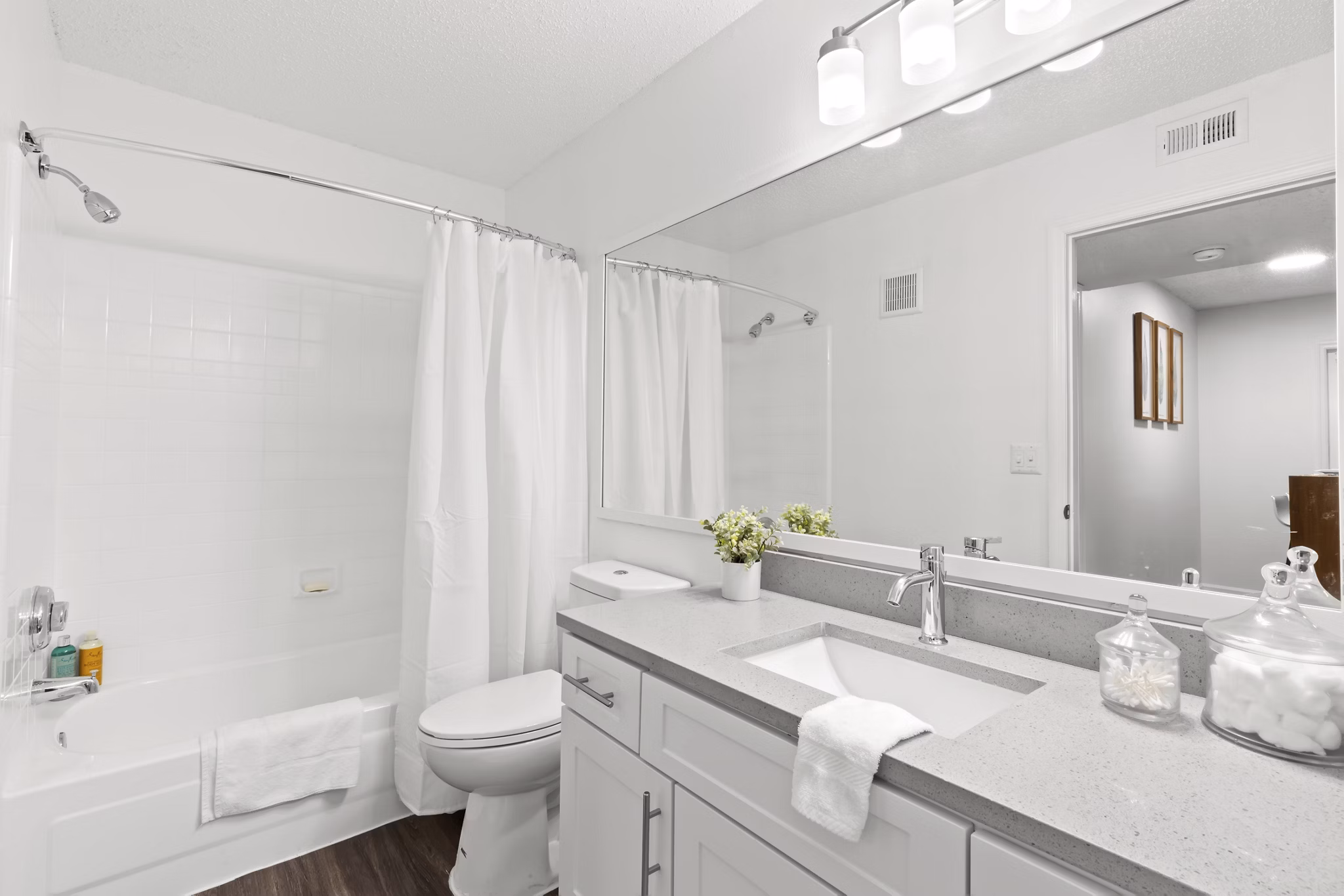 Bathroom featuring modern fixtures and granite countertops in Avana City Park Apartments
