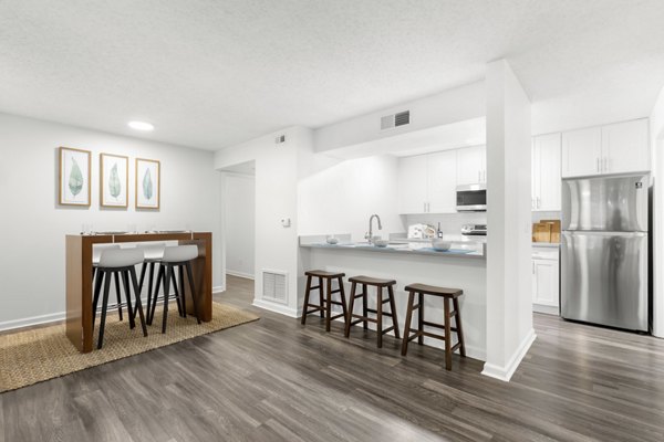 Dining room with modern dÃ©cor and elegant lighting in Avana City Park Apartments, offering luxury urban living experiences
