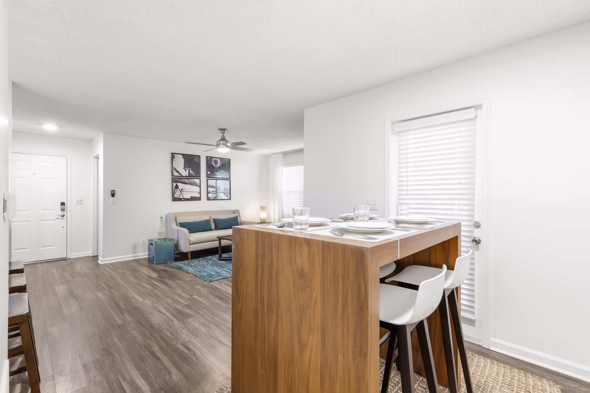 Dining room with sleek modern furniture at Avana City Park Apartments, featuring elegant lighting and spacious layout