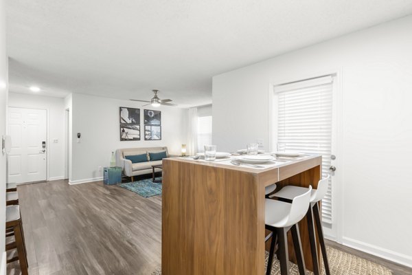 Dining room with sleek modern furniture at Avana City Park Apartments, featuring elegant lighting and spacious layout