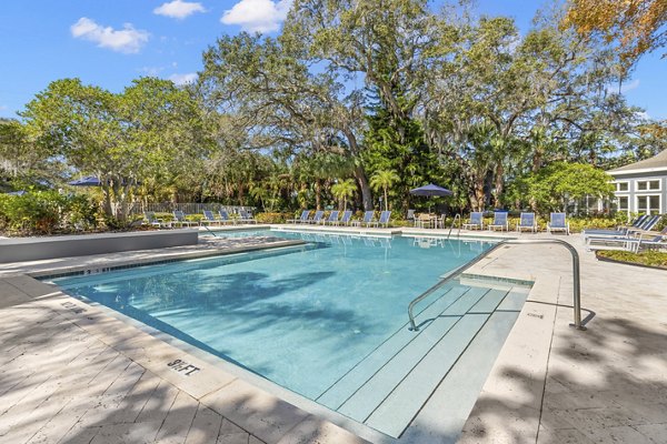 Inviting pool area with loungers at Avana City Park Apartments, ideal for relaxation and leisure moments in a luxury setting
