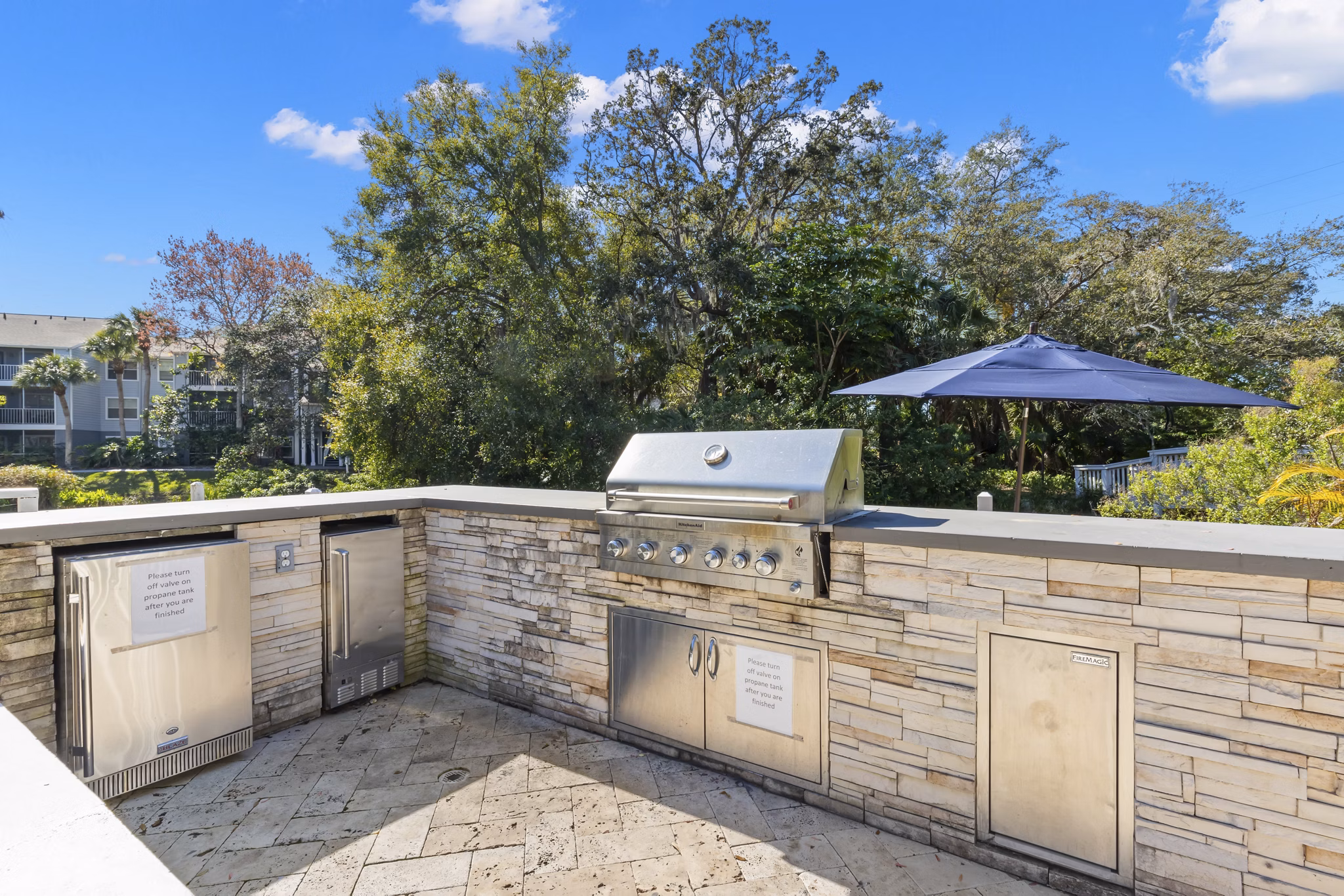 Outdoor grill area/patio featuring modern seating at Avana City Park Apartments for residents to enjoy casual gatherings and cookouts