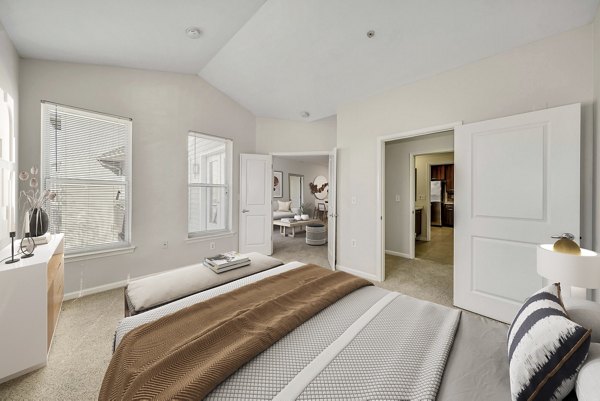 Cozy bedroom with modern furniture at The Stories Apartments, offering luxury living spaces and amenities