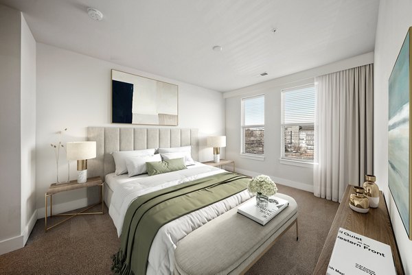 Cozy bedroom with modern furnishings at The Stories Apartments