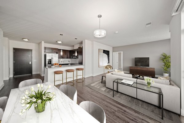 Dining room featuring elegant decor and modern lighting at The Stories Apartments