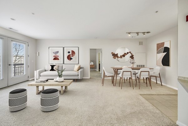 Stylish open-concept dining and living room featuring modern decor at The Stories Apartments