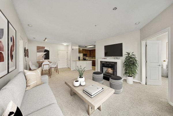 Living room with modern decor and large windows at The Stories Apartments, offering comfort and style