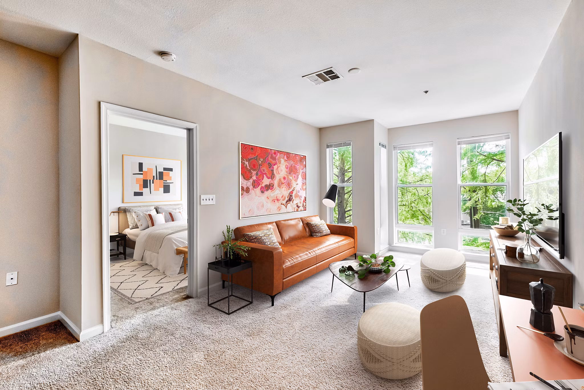 Spacious living room with contemporary furnishings in The Stories Apartments
