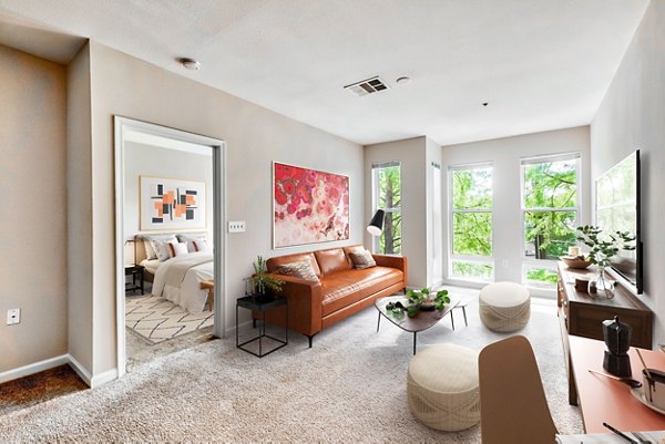 Spacious living room with contemporary furnishings in The Stories Apartments