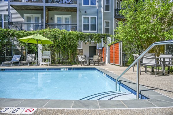 Relaxing poolside experience at The Stories Apartments with luxurious lounge chairs and modern design
