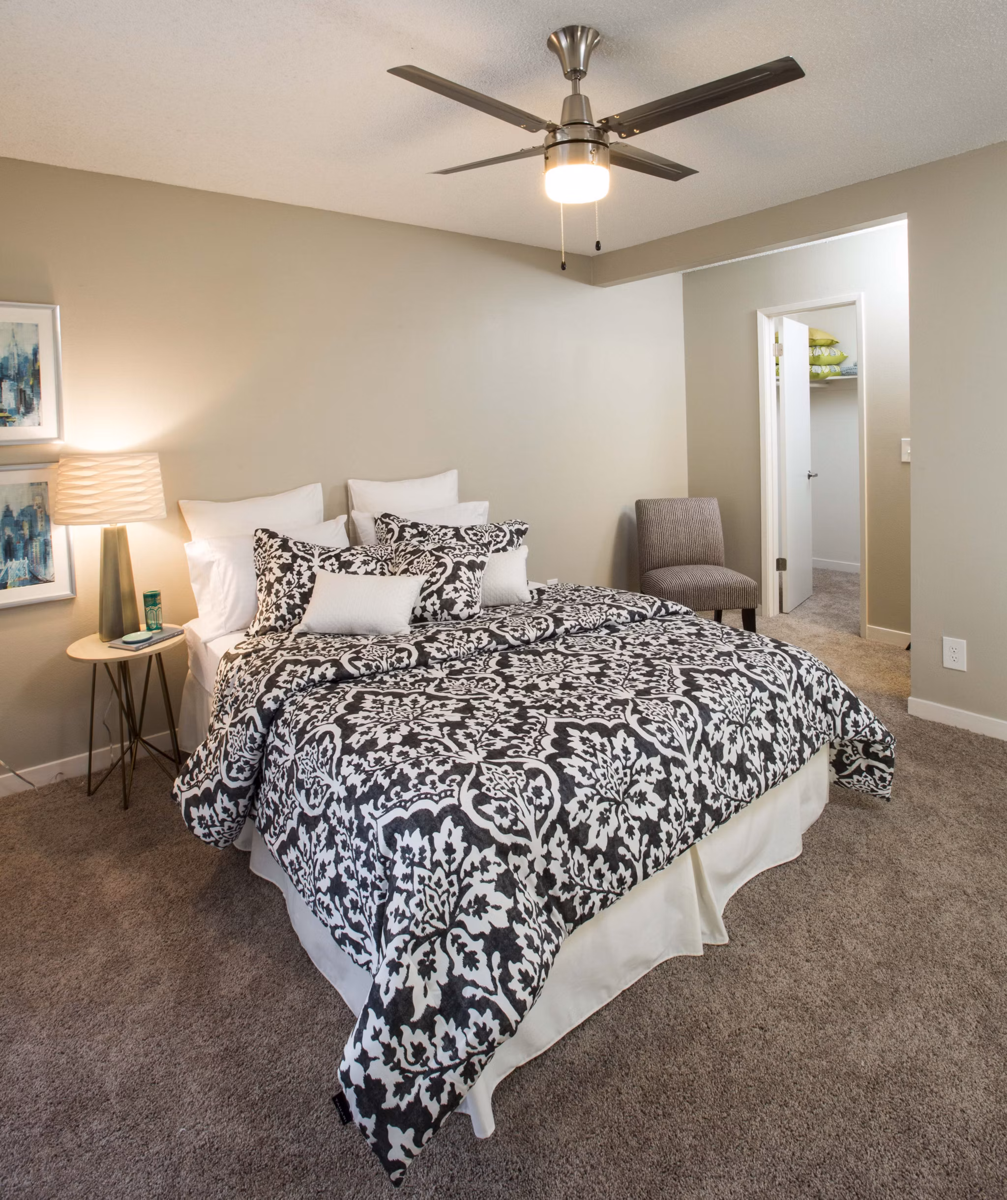 Bedroom with stylish decor and large windows in Amara Apartments, luxury housing option for comfortable living