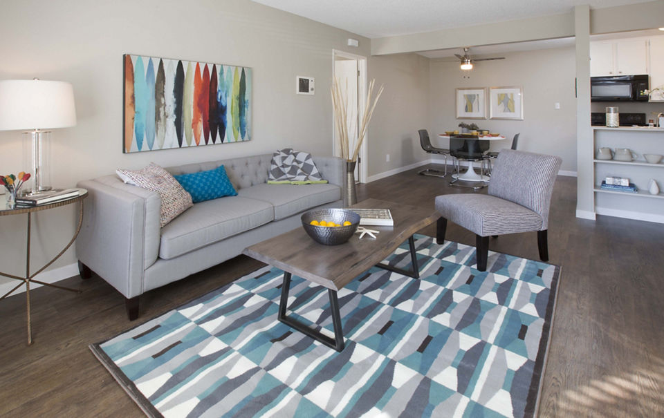 Spacious living room with modern decor and natural light at Amara Apartments